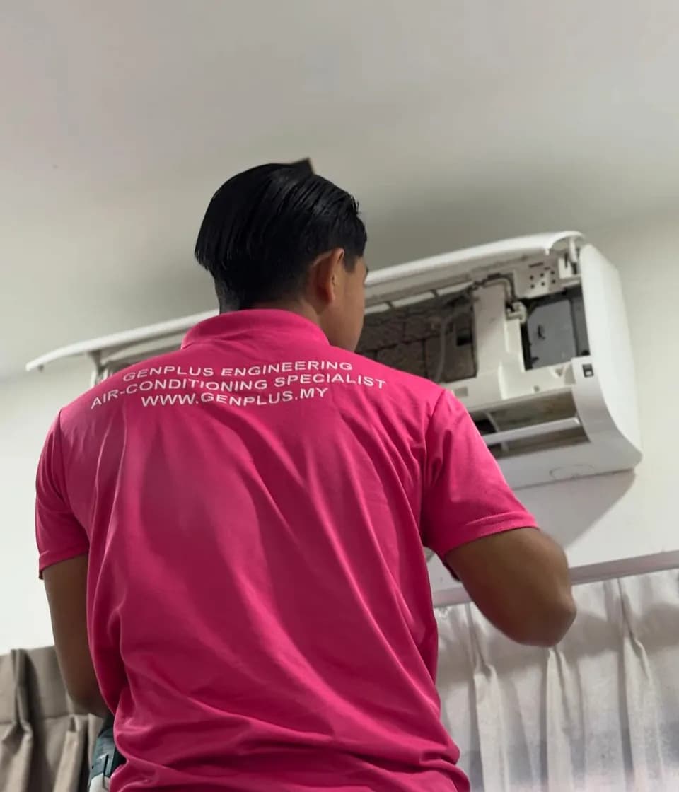 GenPlus Engineering technician completing wall-mounted aircond installation work in Petaling Jaya